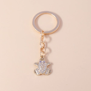 Detailed view of frog keychain with gold-plated base and sparkling white rhinestones