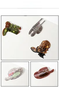Detail view of retro cowboy boot and hat hair clips with marble texture patterns