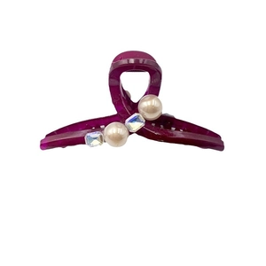 Elegant deep red shark hair claw with pearls and rhinestones on a clean white background