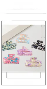 Detail view of large marble texture shark hair clips in various elegant patterns