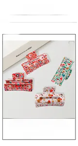 Close-up of colorful cartoon Christmas themed hair clips with snowman and reindeer patterns