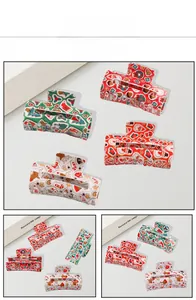 Detail view of Christmas themed hair claws with festive patterns and metal spring mechanism