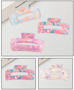 Detailed macro view of marble textured acetate hair claw clips with hollow square design