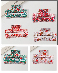 Detailed close-up of festive Christmas claw clips featuring reindeer and snowman patterns