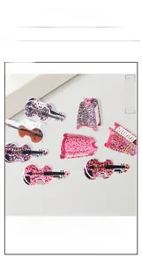 Detailed set of leopard print violin and dress shaped hair clips on display card