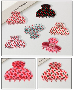 Détails rapprochés de pinces à cheveux aux motifs cerises en diverses couleurs pastel