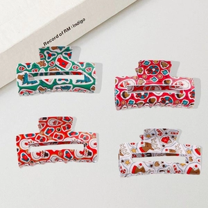 Set of four colorful Christmas hair claws with festive patterns like Santa and reindeer