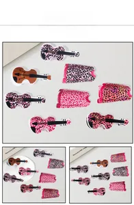 Detailed macro view of acrylic leopard print guitar and dress shaped hair claw clips