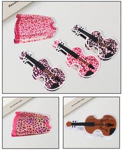 Detailed macro view of creative violin and guitar shaped leopard print acetate hair claws