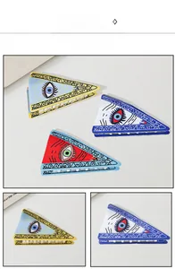 Detailed view of large PVC claw clips with Evil Eye pattern in blue, yellow and red colors