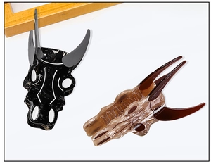 Detail of steer skull hair claw clips in black marble and amber tortoise patterns