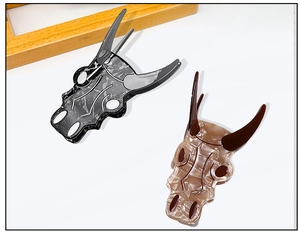 Detailed view of abstract bull skull hair claws in marble and amber acetate finishes