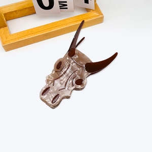 Unique bull skull shape hair claw clip with brown marble texture and retro design
