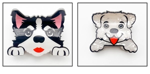 Close-up of cute acrylic cartoon dog hair clips in black and white marble patterns