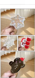 Macro detail of snowman and snowflake acetic acid hair clips with festive rhinestones