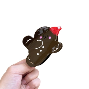 Gingerbread man hair clip with red Christmas hat made of glossy acetate resin