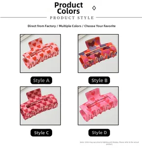 Detail view of four square hair claw clips featuring red heart patterns and metal springs