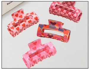 Detail shot of four different heart patterns on square claw clips with cutout designs