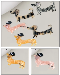 Detail view of acetate dachshund hair clips with leopard print and rhinestone accents