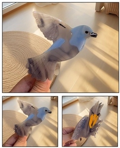 Vue détaillée d'une pince à cheveux en acide acétique en forme d'oiseau au motif marbré