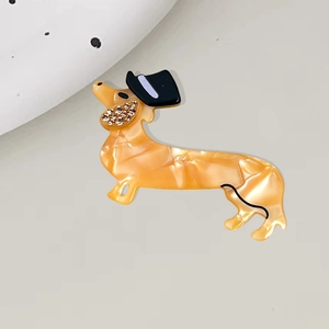Cute dachshund hair clip in amber marble acetate with tiny black hat and sparkling crystals