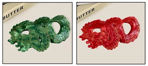 Detail of red and green acetate dragon hair claws with gold brushed silk patterns