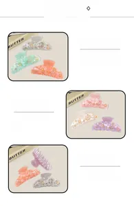 Detail of acrylic hair claws with sparkling rhinestones and golden star motifs