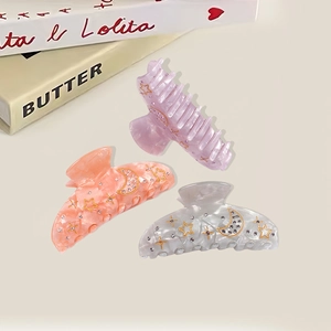 Elegant acrylic hair claws with rhinestone moon and star patterns for thick hair