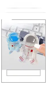 Detail view of two cute astronaut shaped acetate hair claws in blue and pearly white