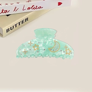 Elegant mint green acrylic hair claw clip with gold star and moon patterns and rhinestones