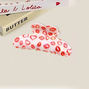Pearlescent white hair claw clip with red hearts and lips pattern in romantic style