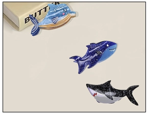 Detailed view of dolphin and shark hair claws in blue marble and starry sky patterns