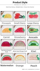 Detail view of various hand-painted acrylic fruit hair clips including strawberry and cherry
