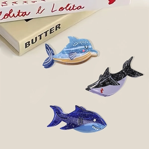 Three ocean-themed dolphin and shark hair claws in blue and purple acetate finish