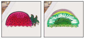 Detail view of acrylic hair claws with dragon fruit and kiwi fruit hand-painted designs