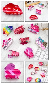 Detail view of colorful acrylic red lip and heart hair clips with LOVE Valentine's patterns