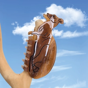 Creative dachshund acetate hair claw clip with brown amber pattern on wood stand
