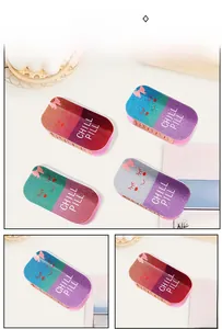 Detailed view of four glittery pill-shaped acrylic hair claws with Chill Pill text
