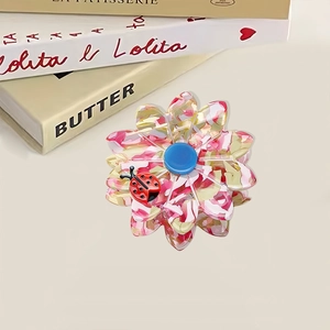 Floral acetate hair claw clip with ladybug detail and elegant pink floral pattern