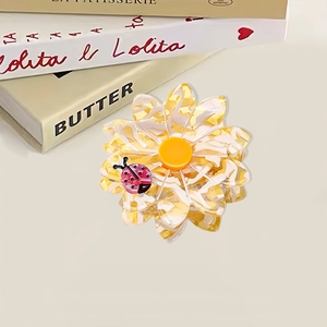 Daisy flower hair claw clip in translucent yellow acetate with a small ladybug detail