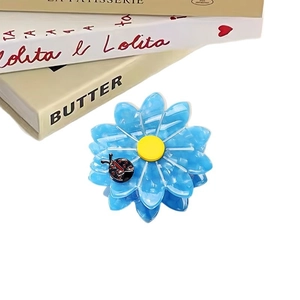 Sunflower hair claw clip in blue acetate with a cute ladybug detail for women