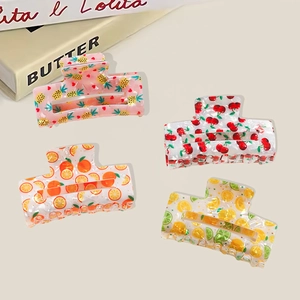 Set of four fruit pattern hair claws featuring pineapple, cherry, orange, and lemon prints