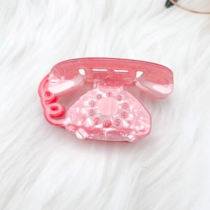 Pince à cheveux téléphone rétro rose avec texture marbrée pour coiffures de fête
