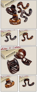 Detail of tortoiseshell hair clips with wave patterns and metal spring mechanism