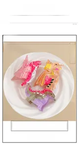 Detailed view of large acetate cartoon dinosaur claw clips with marble texture