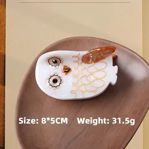 Elegant owl acetate hair claw clip with golden feather patterns and amber crystal details