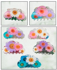 Detailed view of PVC flower hair claws with daisy prints in multiple pastel colors