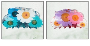 Close-up of cloud-shaped hair claws with daisy prints in blue and pink floral tones