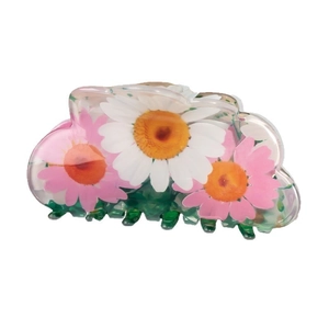 Floral resin hair claw clip with daisy print and green teeth on a white background