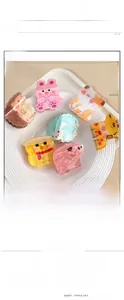 Detail view of colorful acrylic animal-shaped hair claws for girls in soft lighting